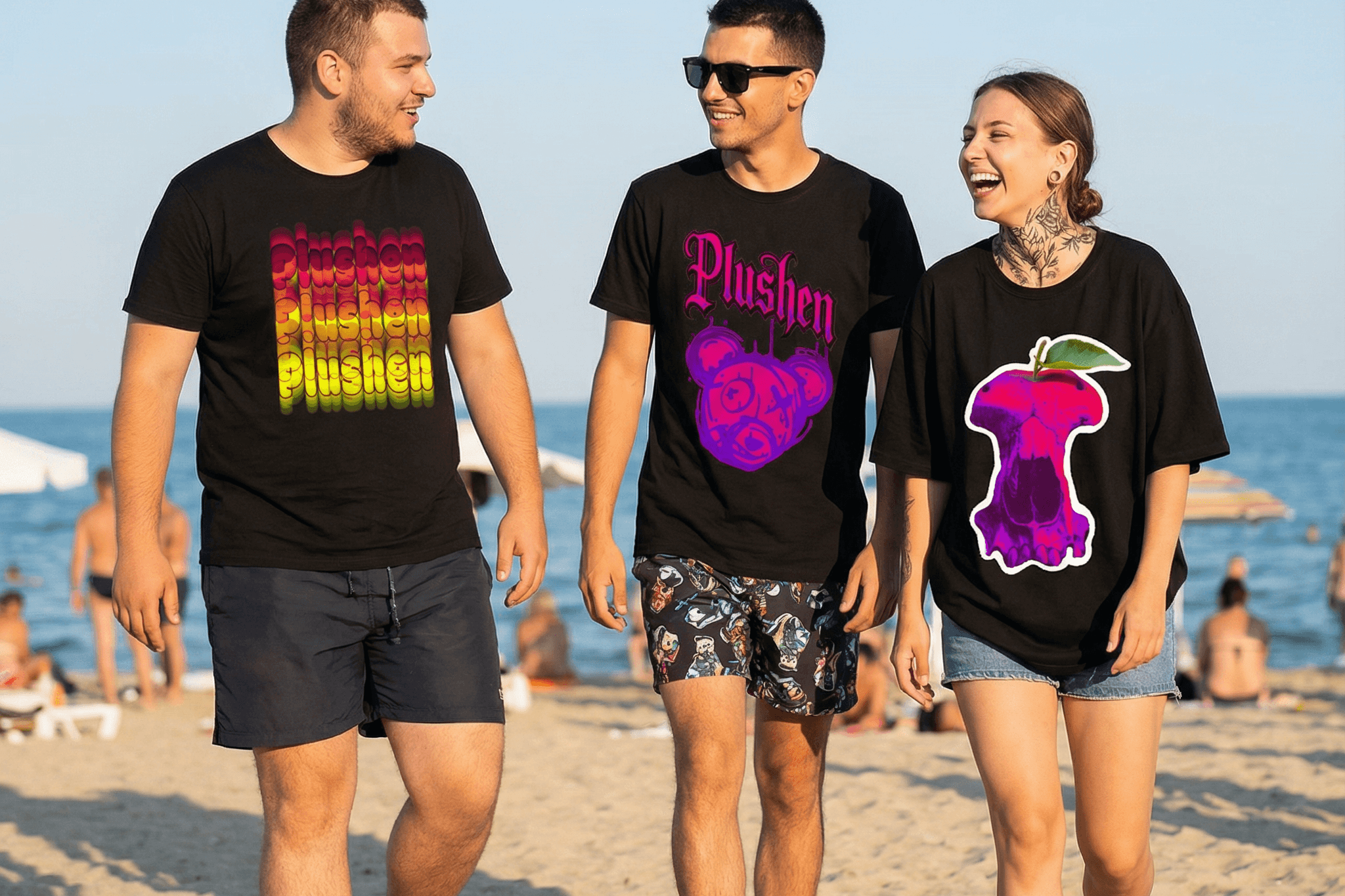 Група приятели на плажа с тениски Plushen, усмихнати, наслаждаващи се на слънце и отстъпки за любими продукти.